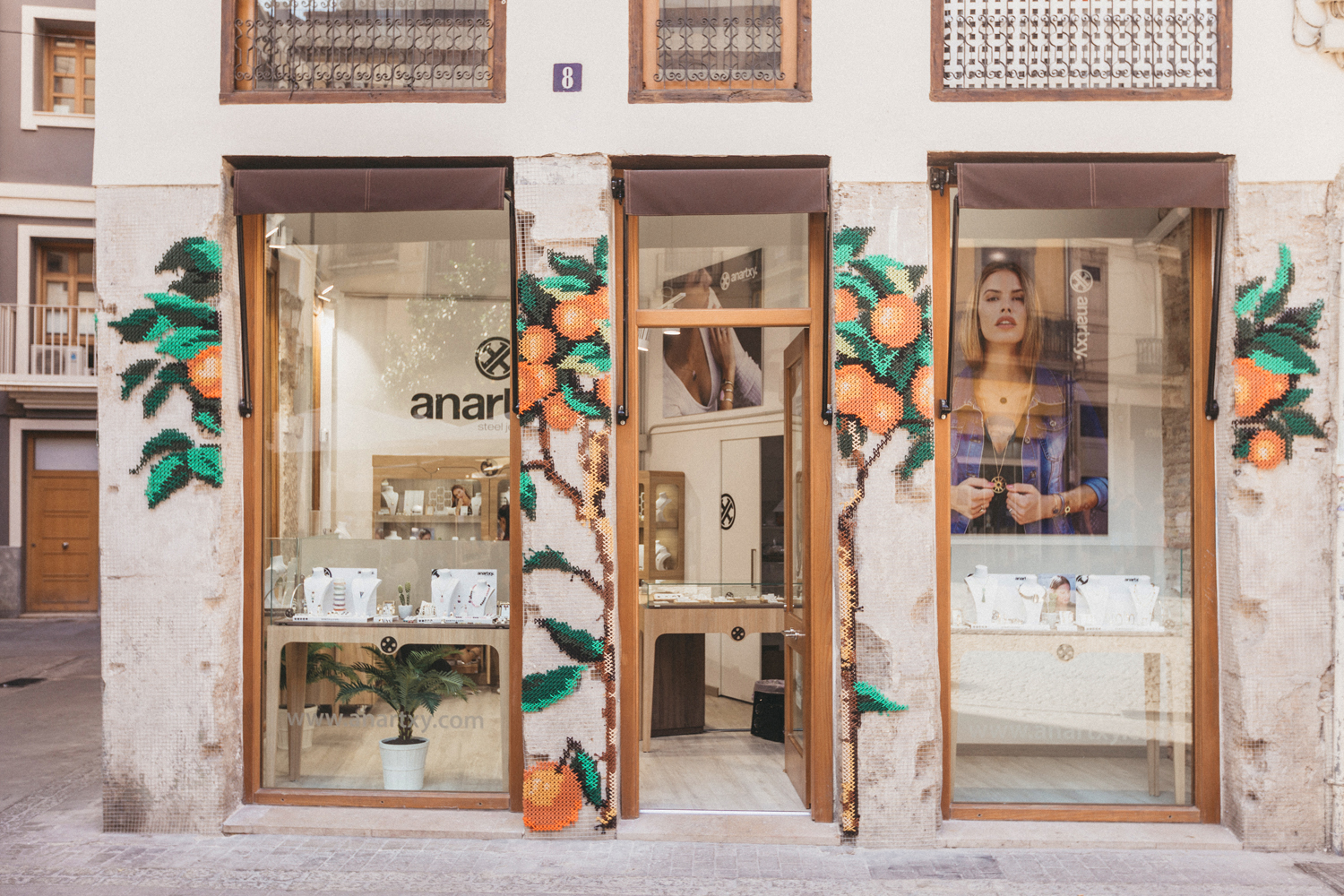 Anartxy — full facade view with embroidered orange trees on all pillars