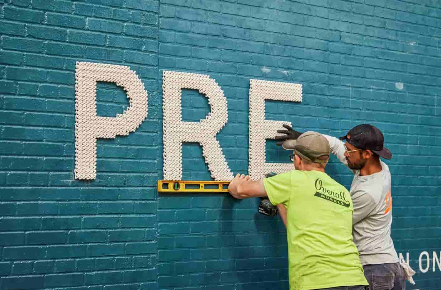 Audible Pride & Prejudice — installation process Bushwick letters being placed