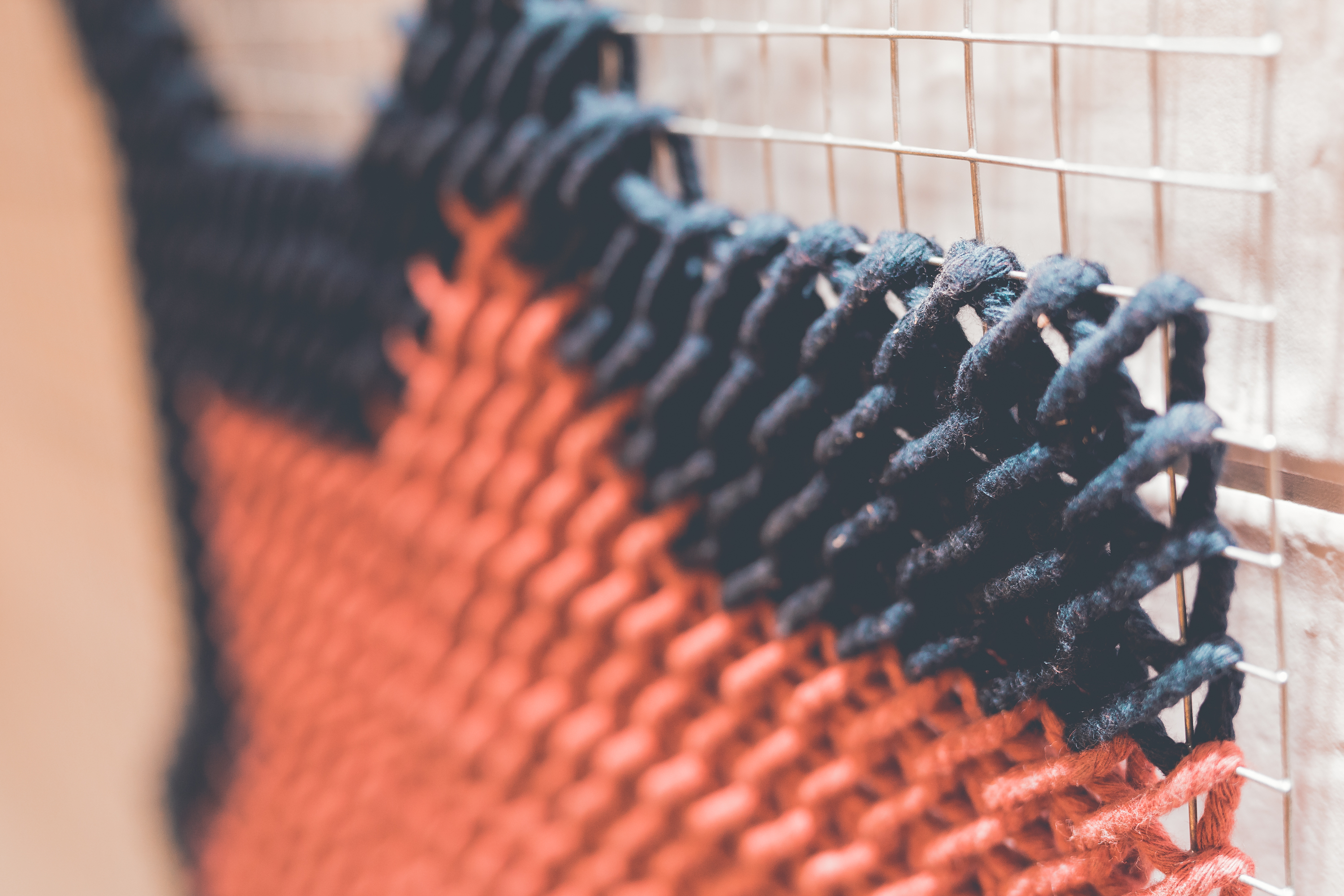 Gayafores — macro detail of orange and dark blue embroidery stitch texture