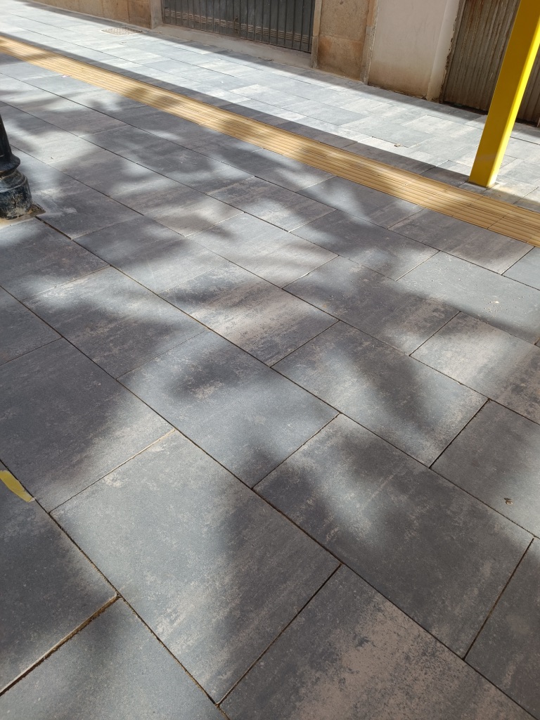 Katarsis — shadow detail on the ground, light filtering through the embroidery