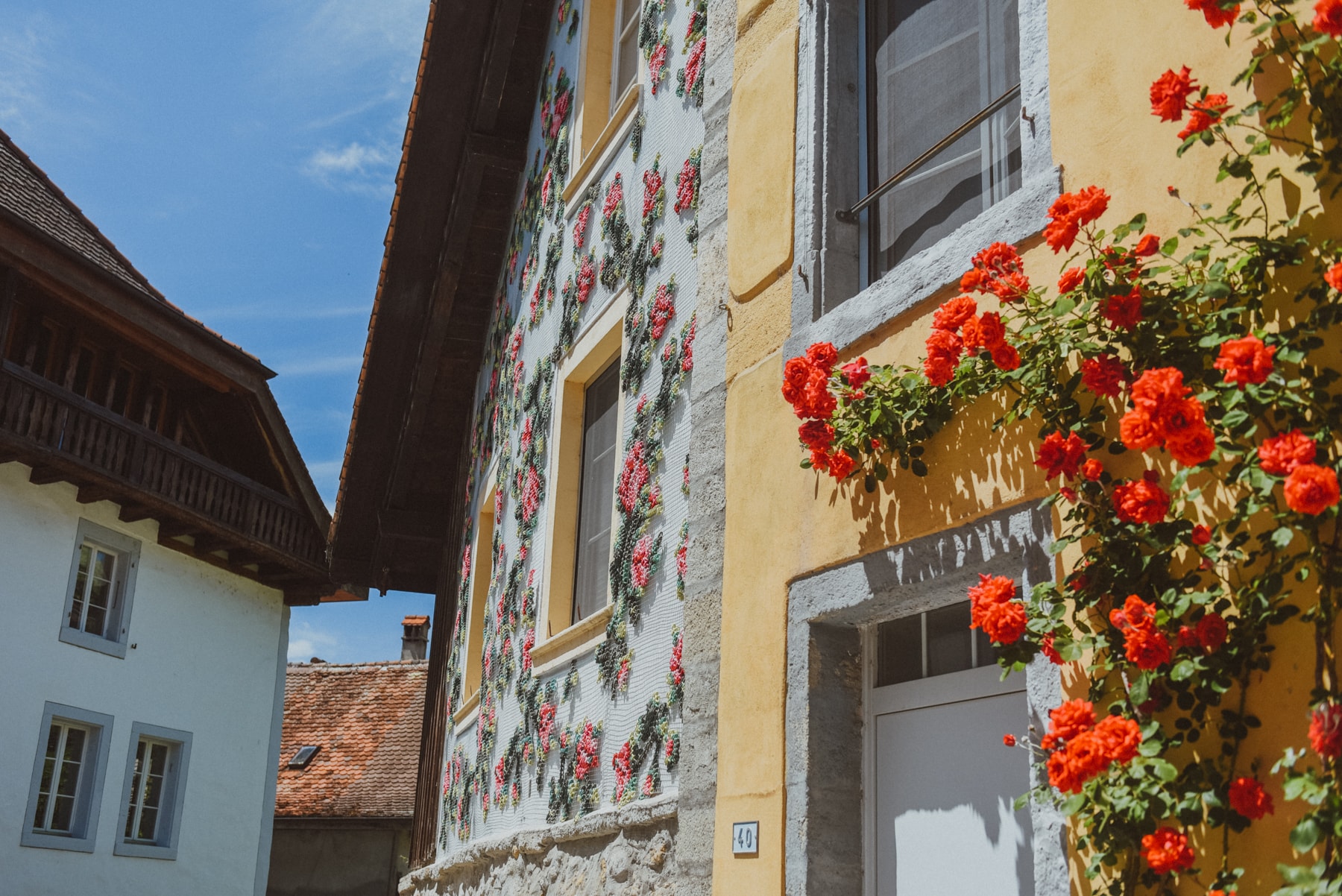 Flores — close view of embroidered facade with real roses in foreground