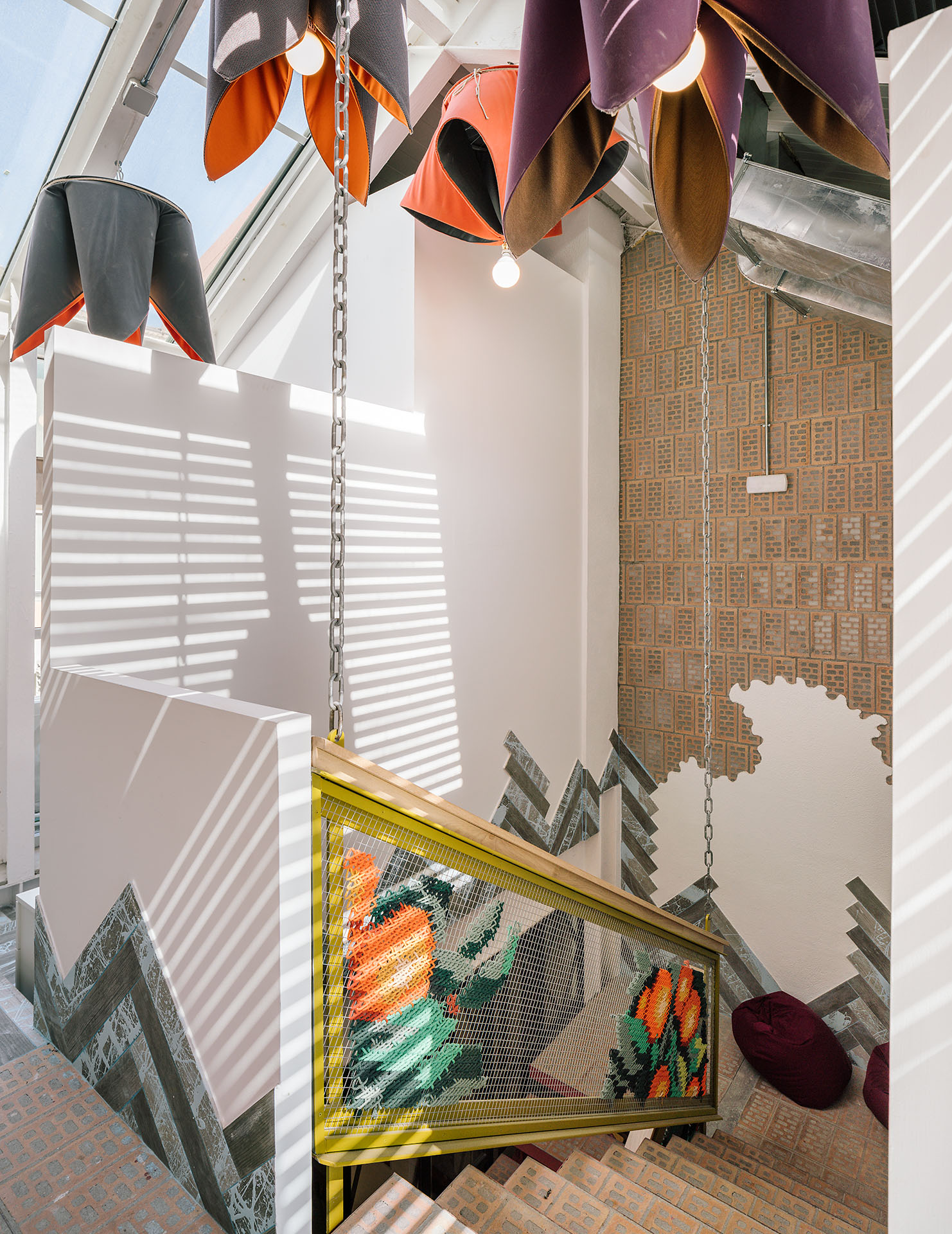 UtopicUs Clementina — top floor view looking down staircase with embroidered railings and skylight