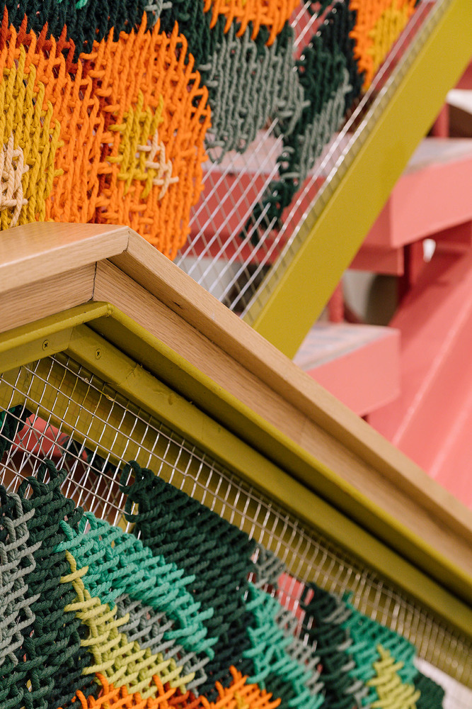 UtopicUs Clementina — macro detail of clementine embroidery stitch on metallic mesh railing