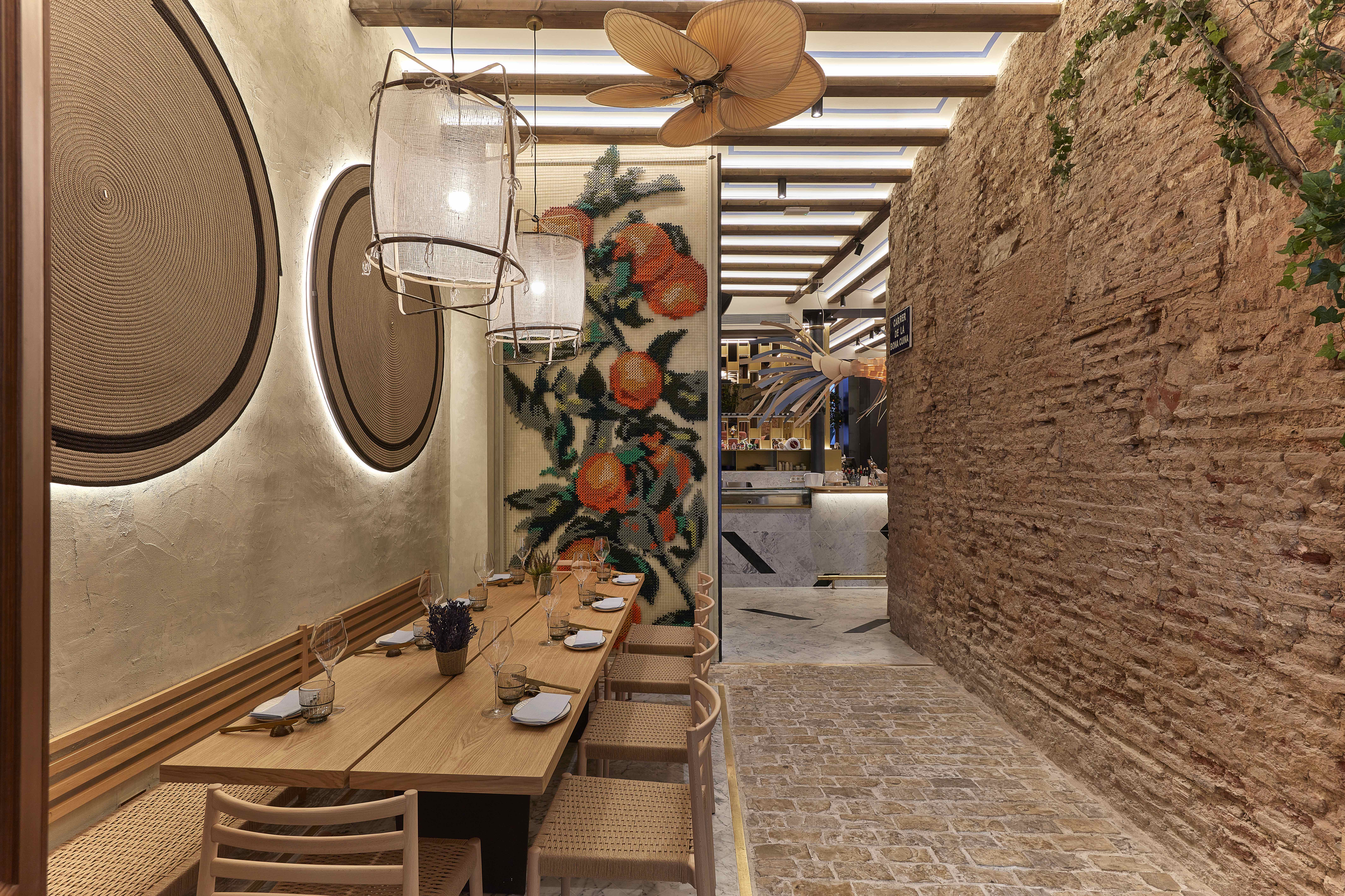 Vaqueta Gastro Mercat — embroidered orange tree panel restaurant entrance Valencia